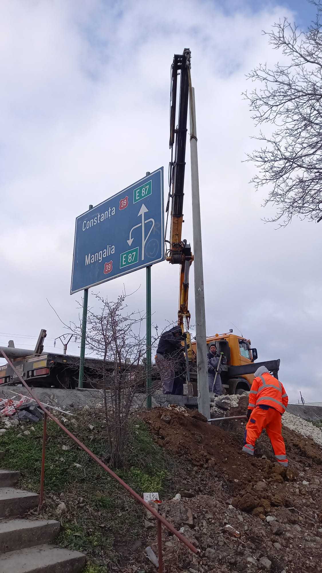 installation of electrical post along highway using mobile crane