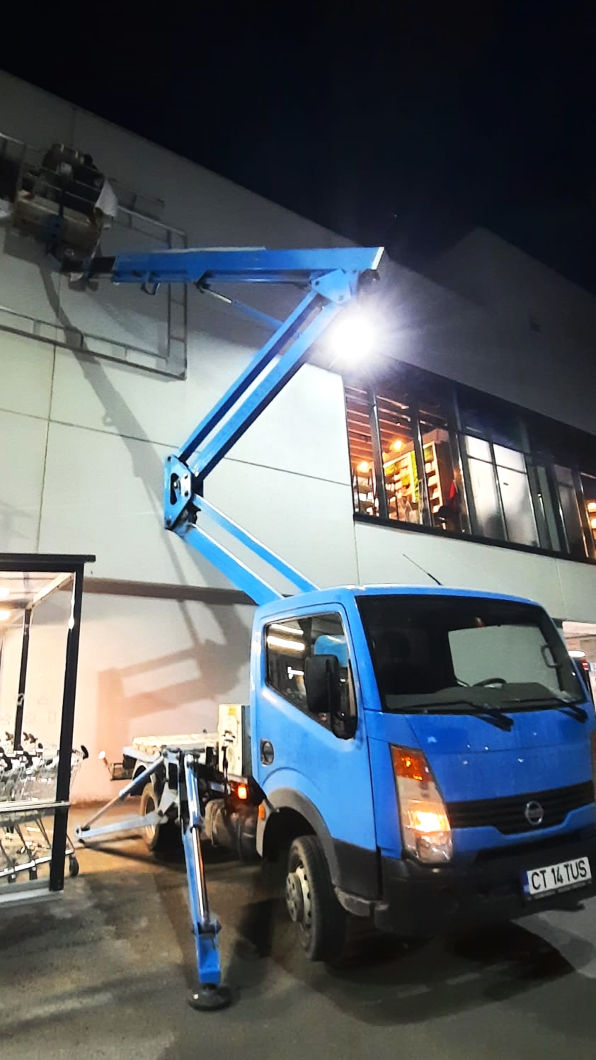 advertising signage posting using a truck-mounted boom lift