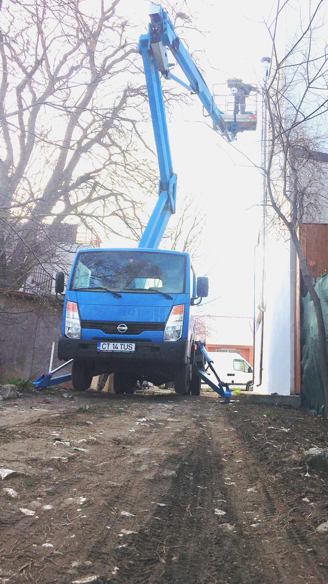 Wall painting work using a truck-mounted boom lift