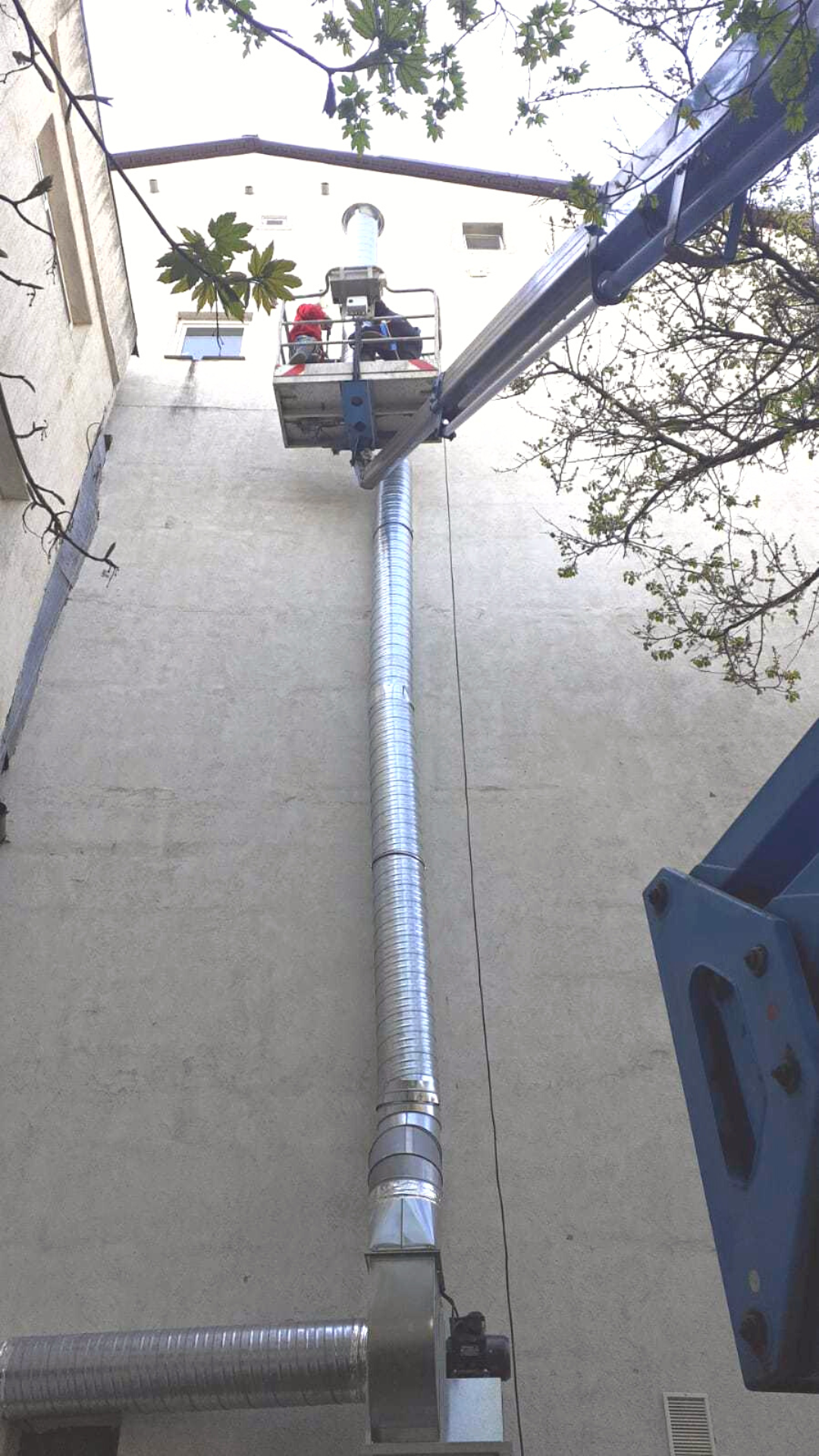 Ventilation tube installation project using a truck-mounted boom lift