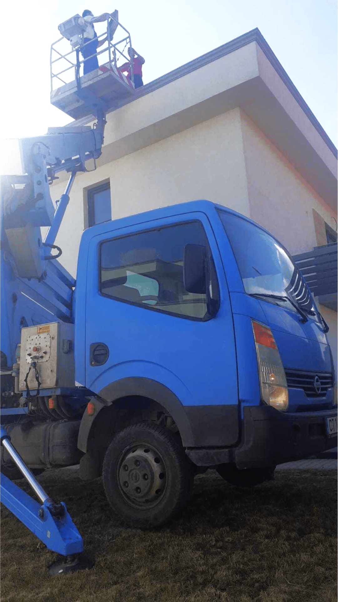 Solar Panel Mounting on a Building Roof with a Truck-Mounted Boom Lift