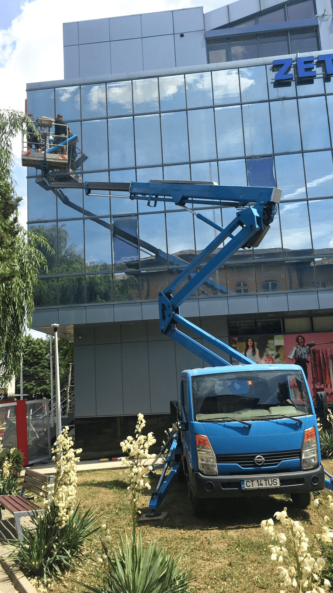 Applying Window Stickers using a Truck-mounted Boom Lift Rental