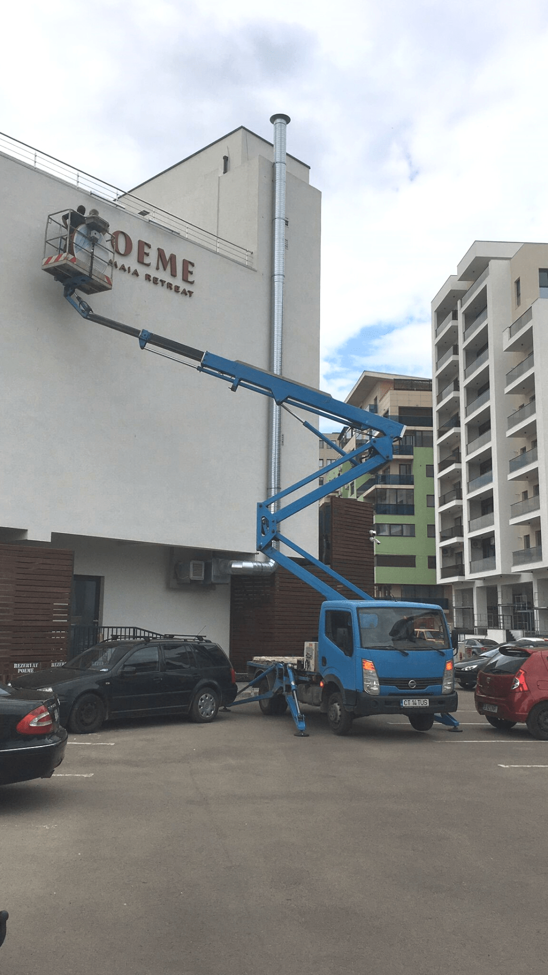 Hotel signage installation project using a boom lift