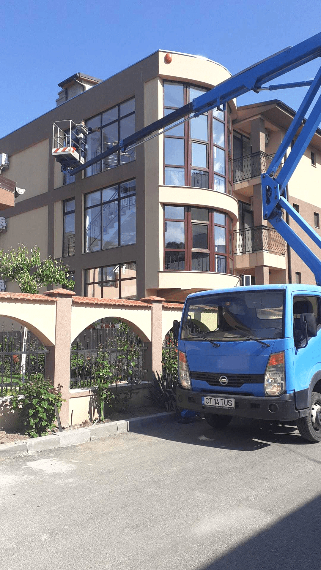 Window cleaning at heights using a truck-mounted boom lift