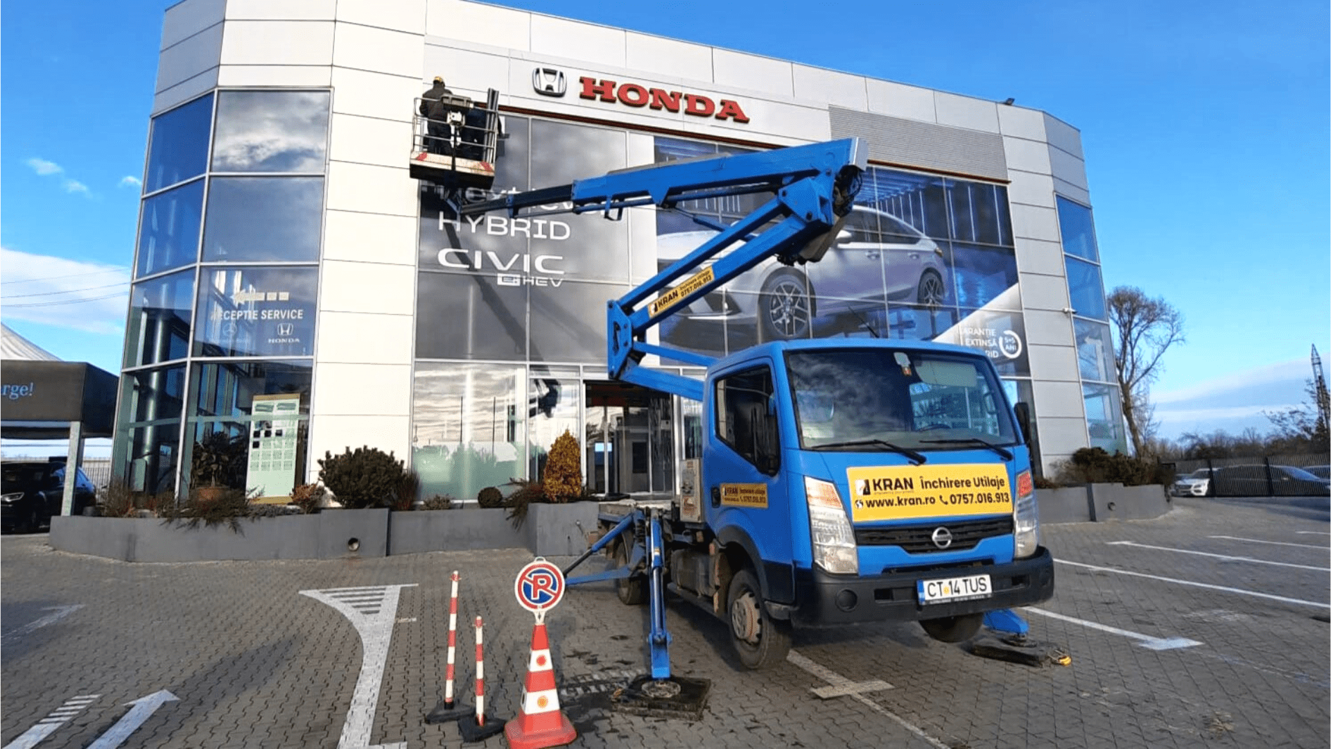 Replacing the Advertising Poster in a Car Dealer using a Truck-Mounted Boom Lift
