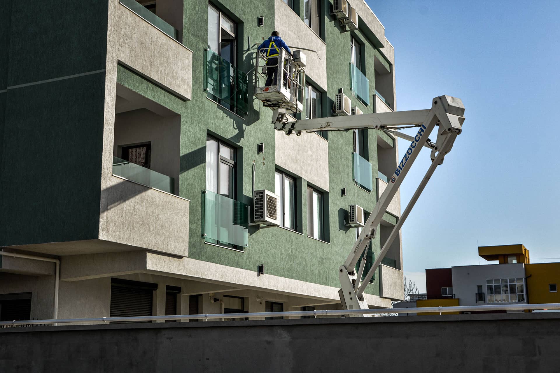 Worker working on a building from a height on a platform